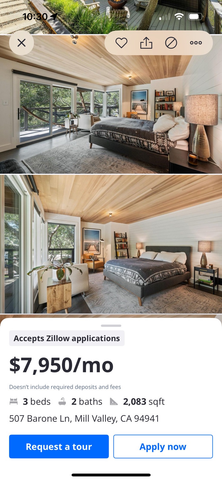 Listing screenshot showing a bedroom with a wood ceiling and large garden-facing windows.