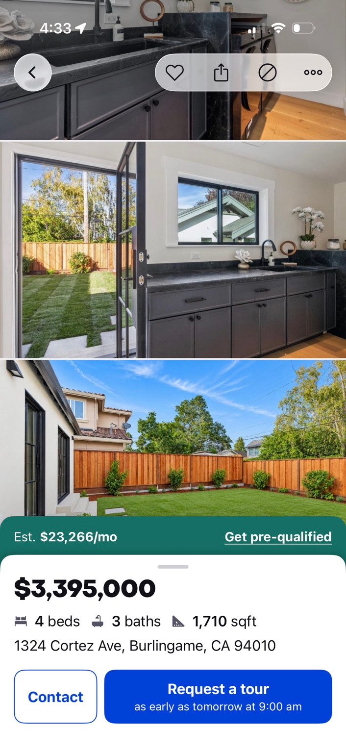 Listing screenshot showing dark kitchen cabinets, glazed garden doors and a lawn.